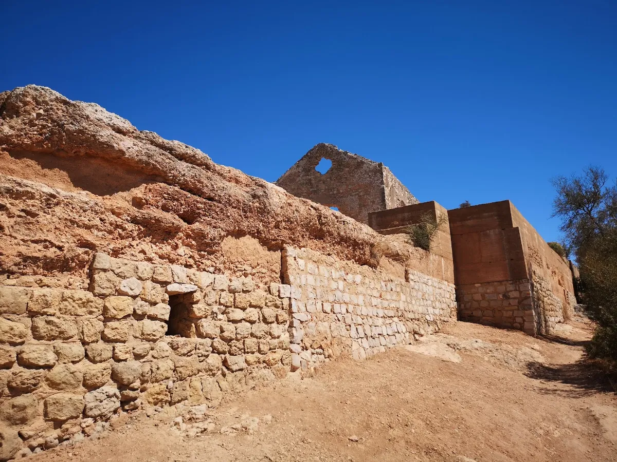 Rammed-earth taipa walls of Paderne Castle with whitewash lines