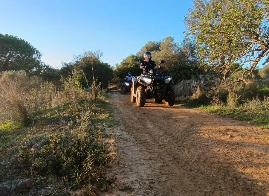 Quad bikes in single file along a country trail during the guided tour