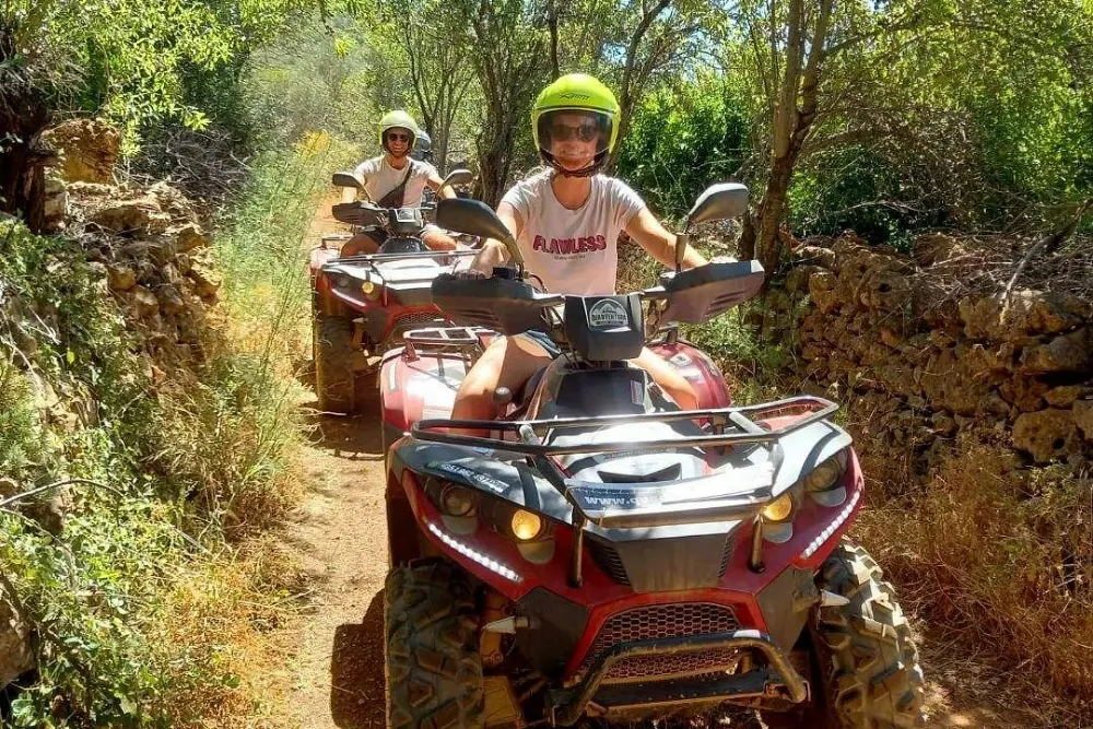 Quad bike on dirt tracks between orange groves and olive trees in the Algarve