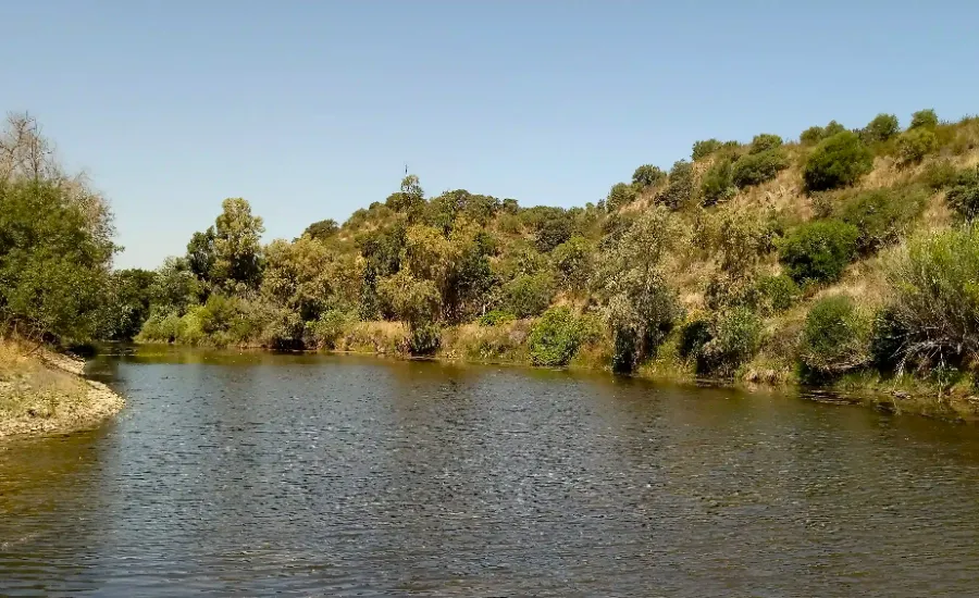 Quad bike group stopping beside a reservoir in the Algarve's interior